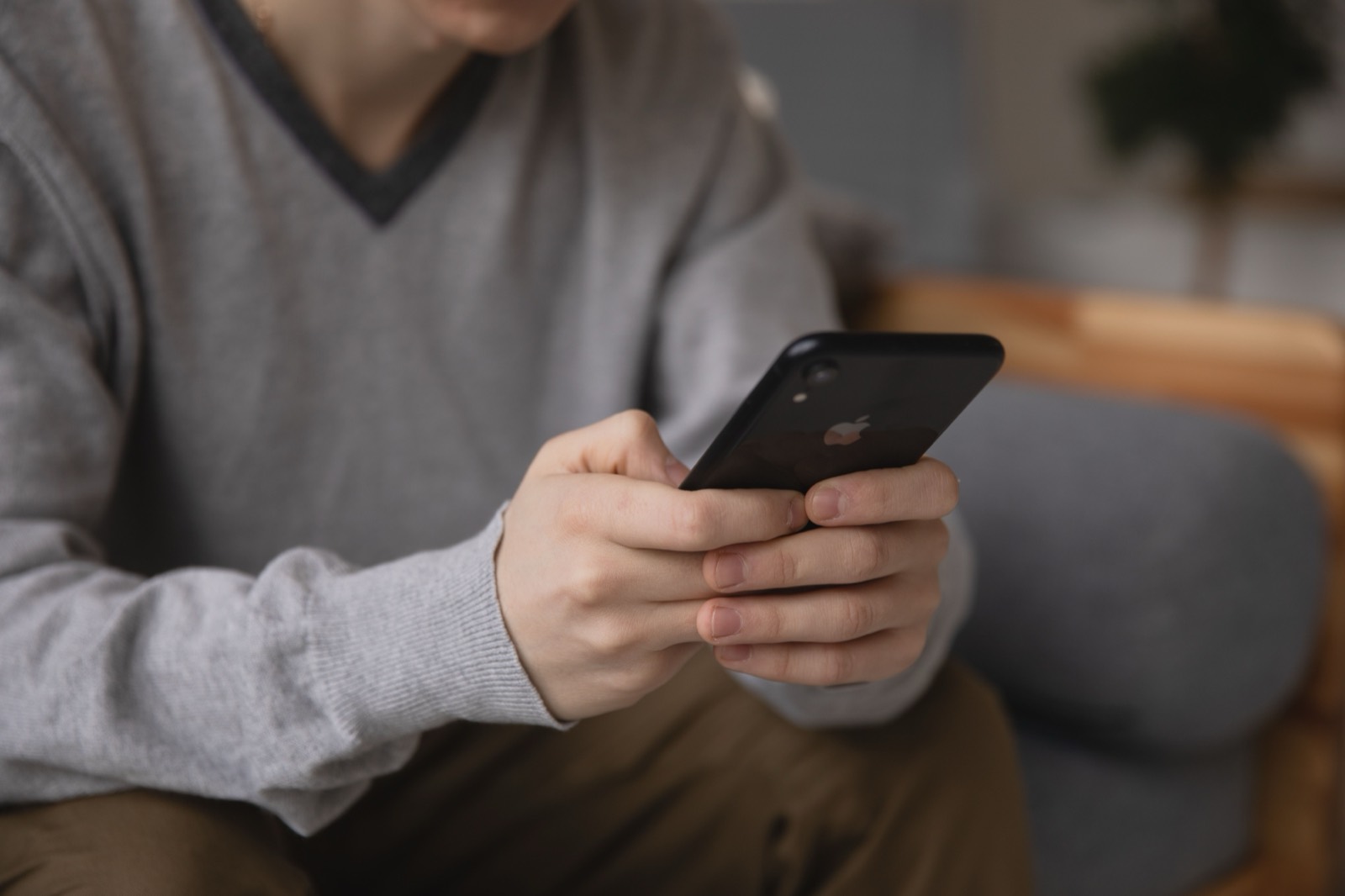 A customer holding a phone, sending repair photos in for an estimate