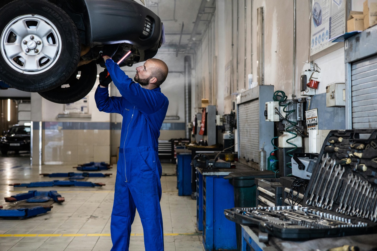 A collision repair shop floor with technicians at work